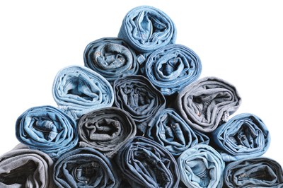 pyramid-of-rolled-up-denim-jeans-isolated-on-white-2023-11-27-04-51-58-utc.jpg